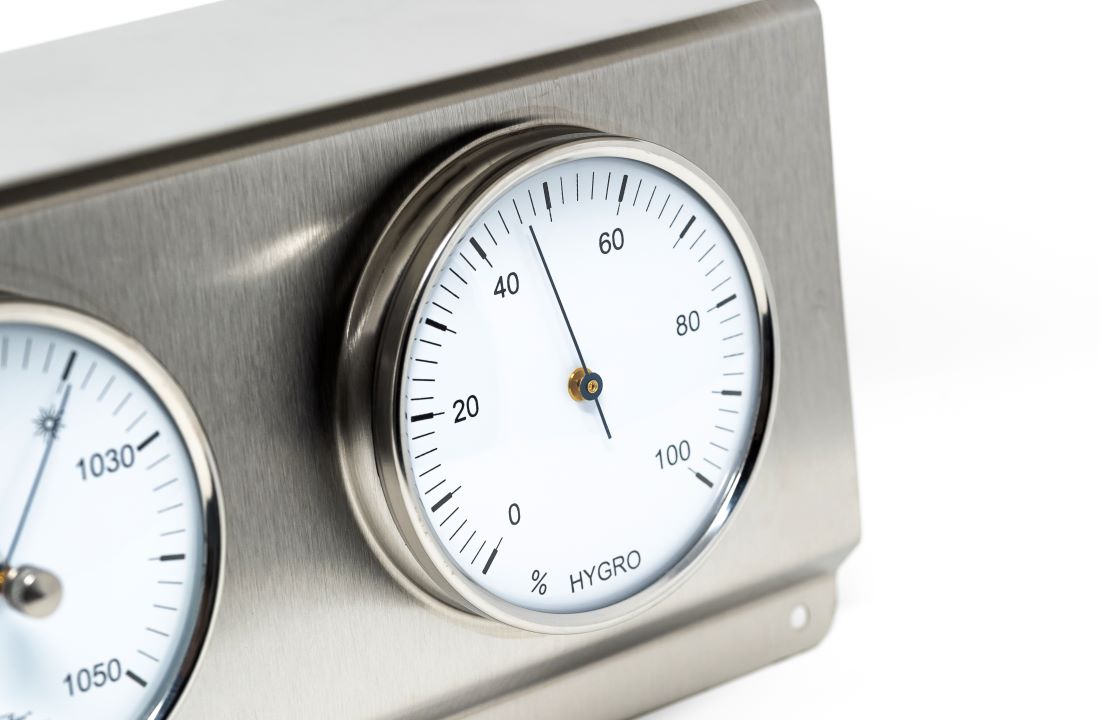 Hygrometer with temperature gauge on a metallic surface