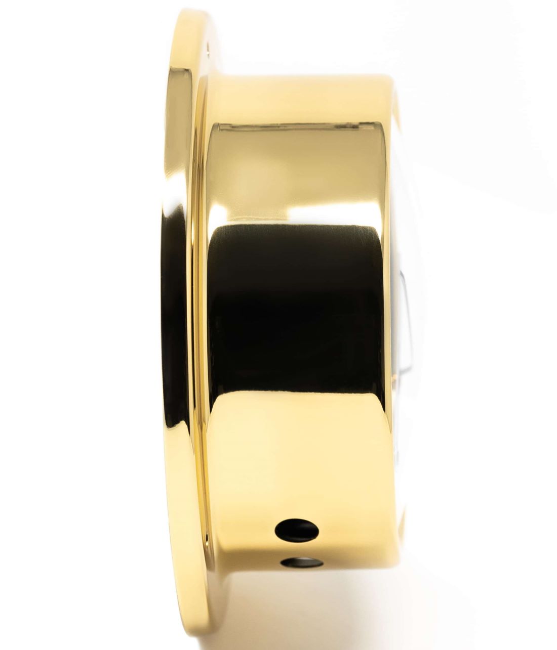 Side view of a polished brass barometer or nautical clock with a round case
