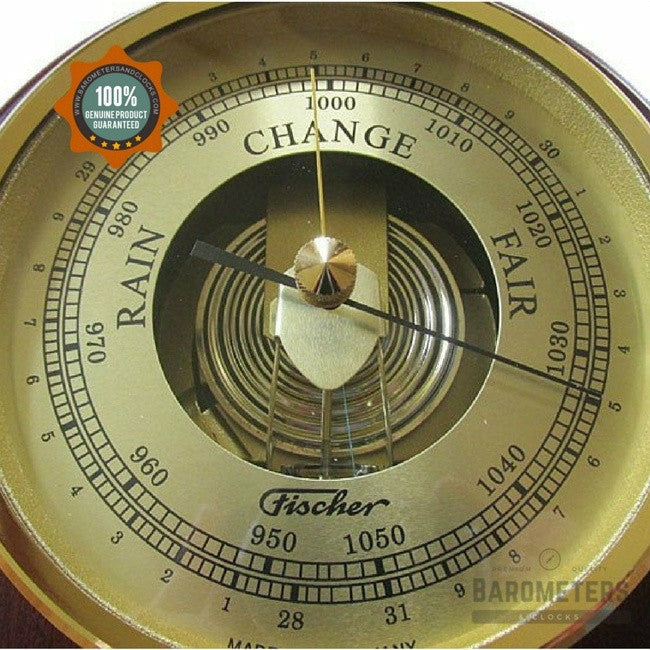 Analog brass barometer with dial showing rain, change, and fair weather indicators
