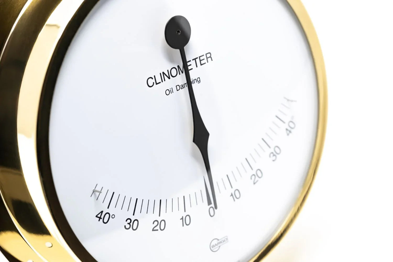 Brass nautical clinometer with white dial and black needle, angle measurement scale visible
