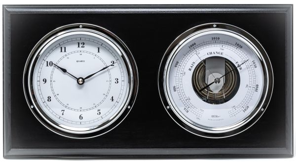 Black panel with chrome-rimmed barometer and clock, weather station home decor.